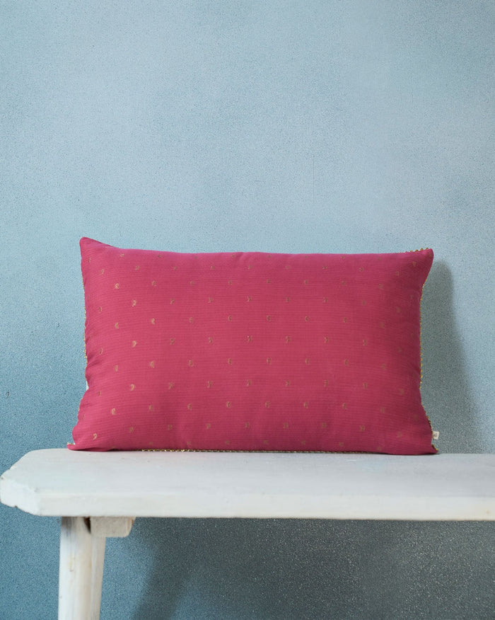 Malam Cushion Cover in pink with small gold motifs scattered across it.