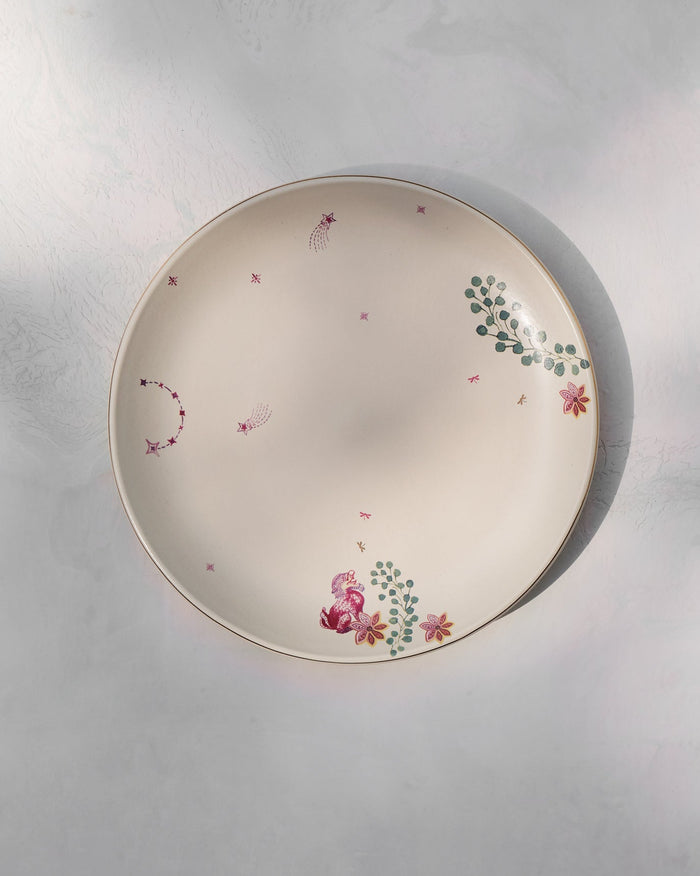 Top view of the Barong Dinner Plate with pink flowers and green sprigs on cream.