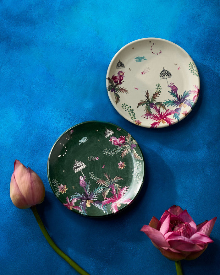 Pair of Barong quarter plates, one cream and one green, with palm motifs.