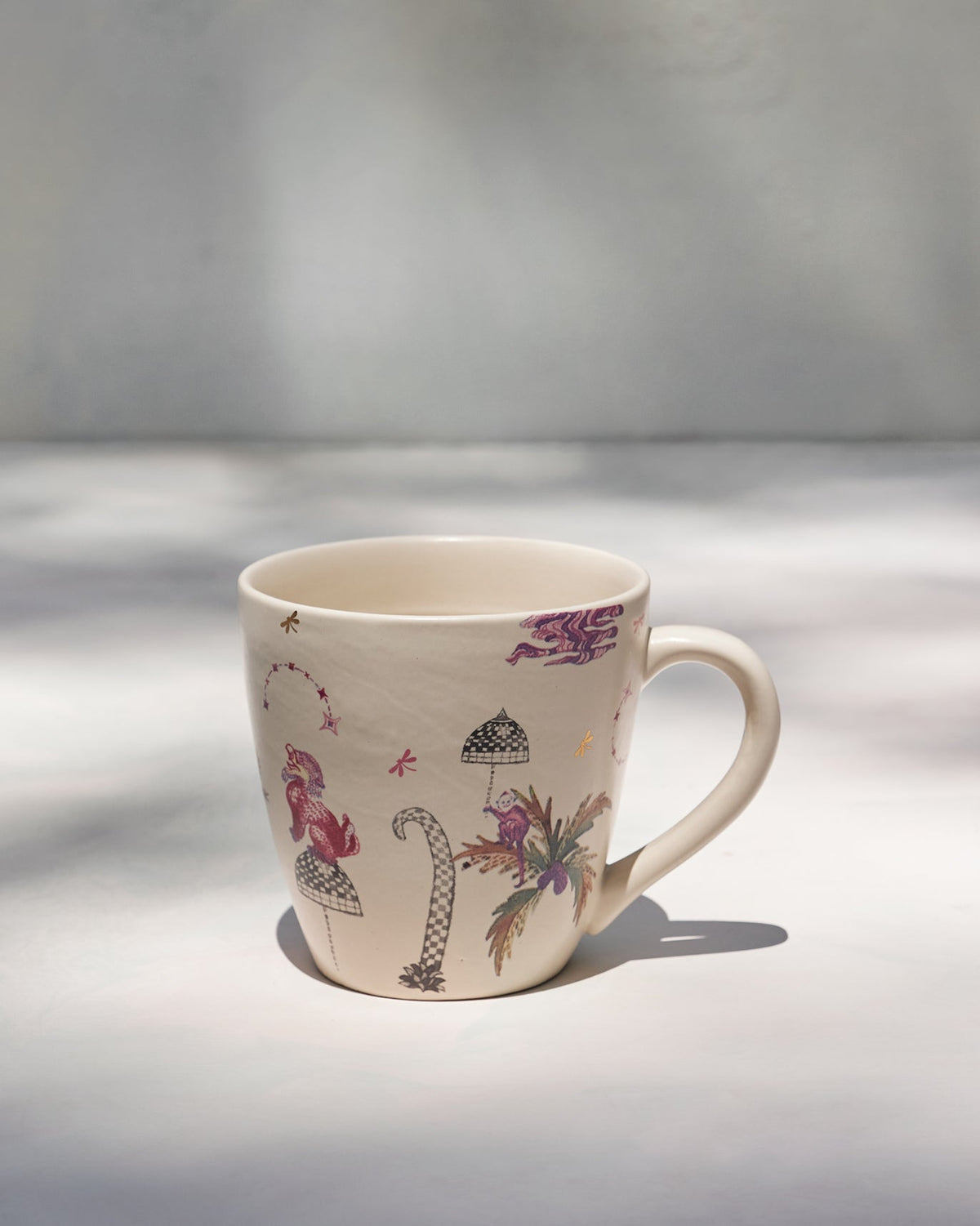 Barong Conical Mug with its handle on the right and printed palm motif.