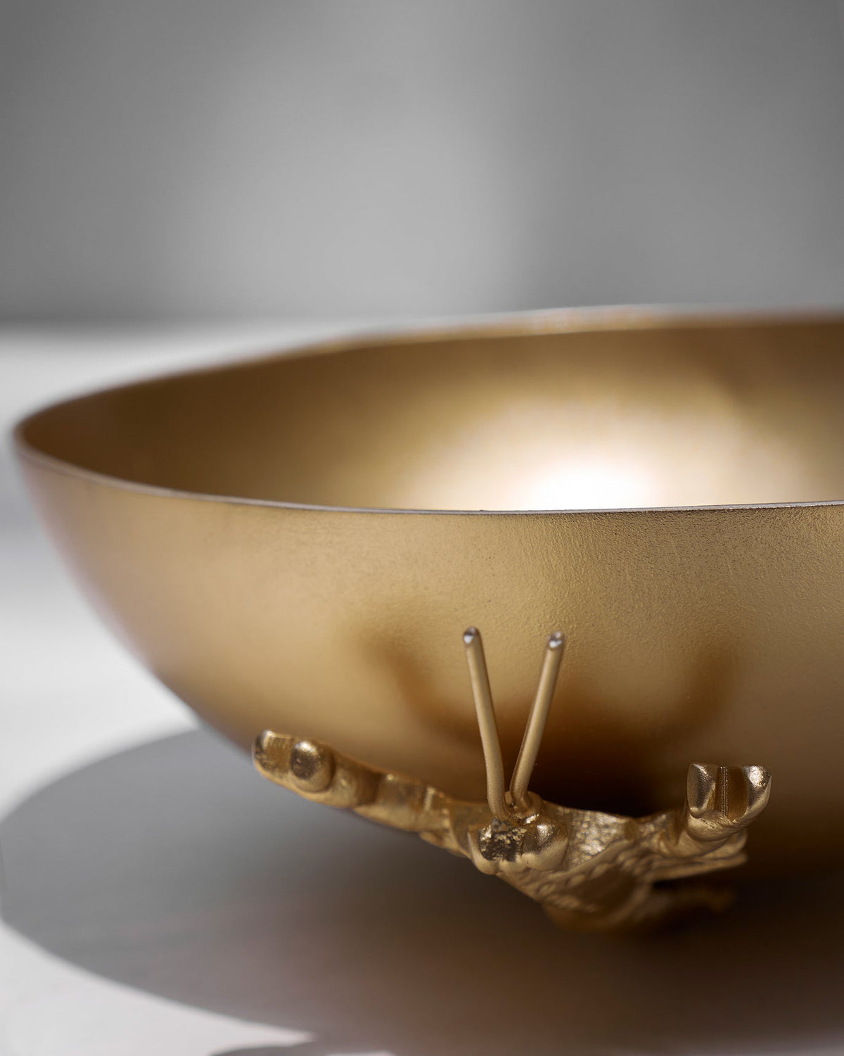 Close-up of the Lobster Home Accent showing its gold bowl and small gold feet.