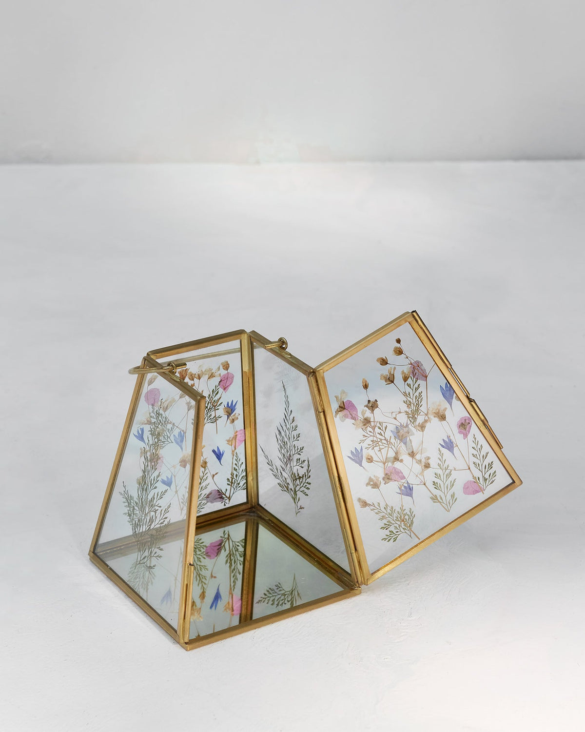 Angled view of the Patio Lantern with its hinged glass panel open.