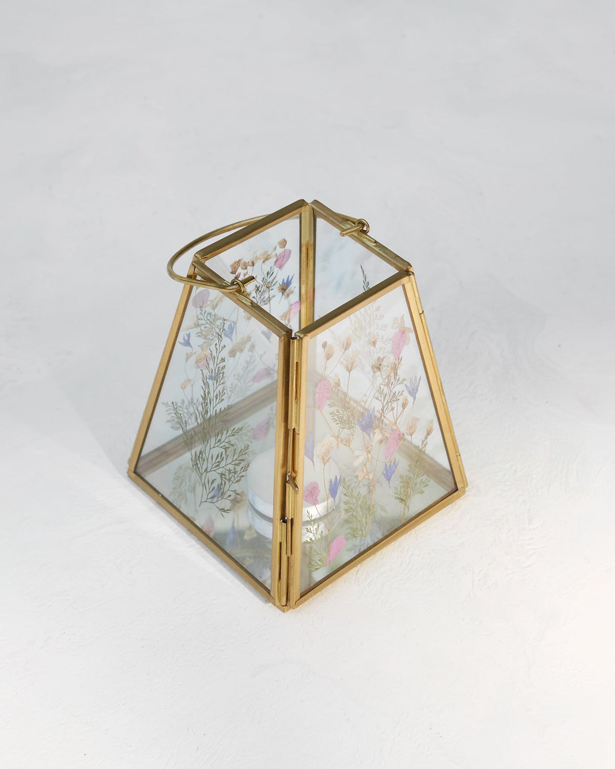 Patio Lantern with a looped handle on top and pressed flowers visible through the glass.