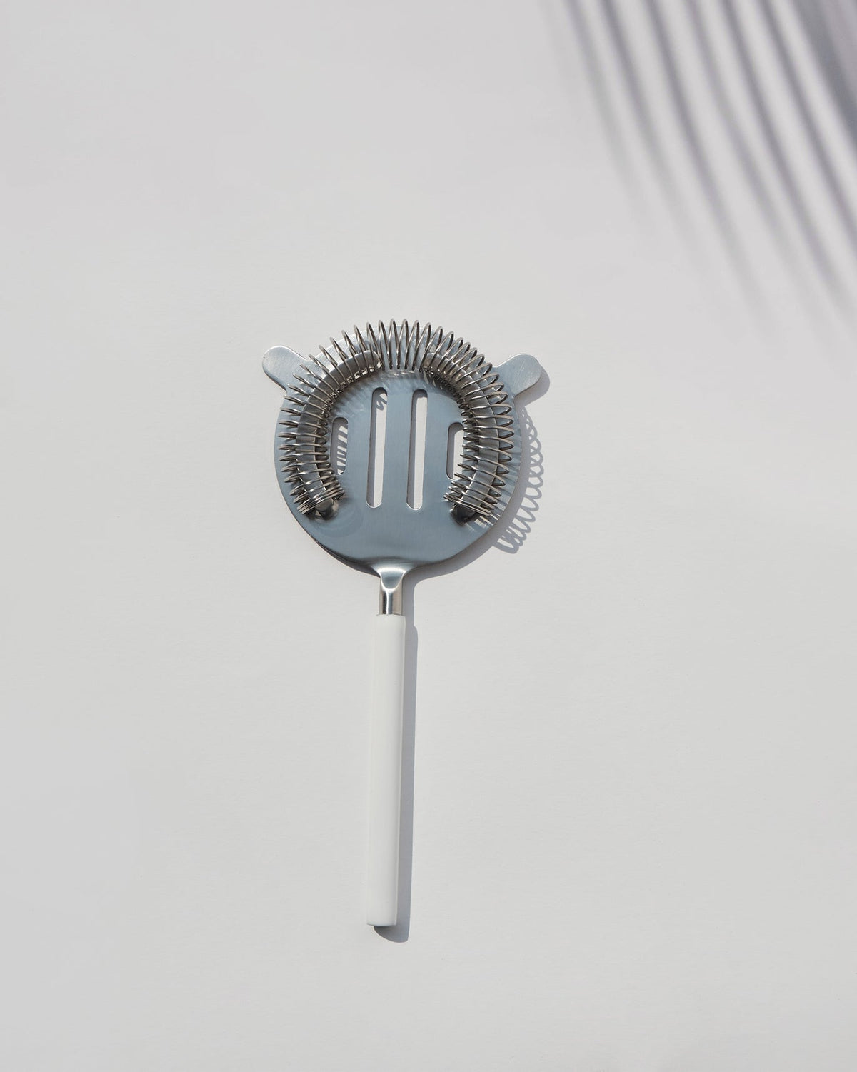 Riverside Cocktail Strainer -White seen from above, with its full white handle.