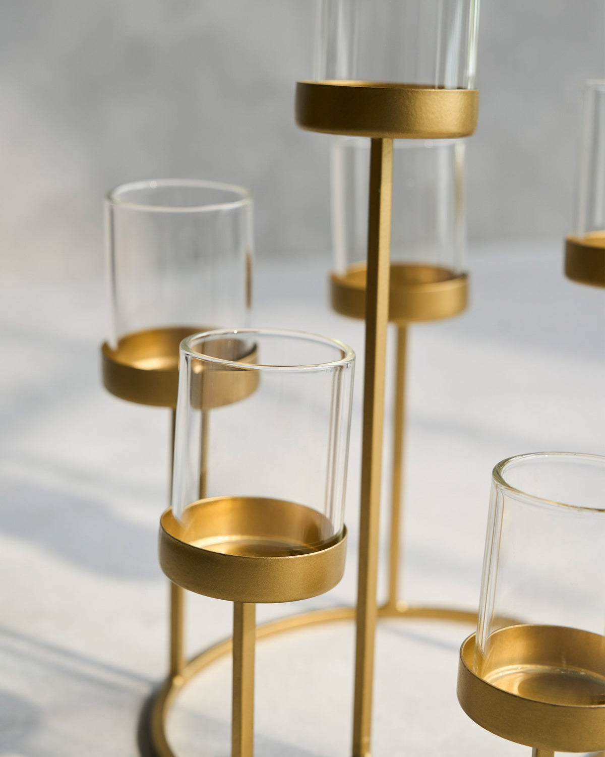 Close-up of Float Votives showing gold cup bases and clear glass sleeves.