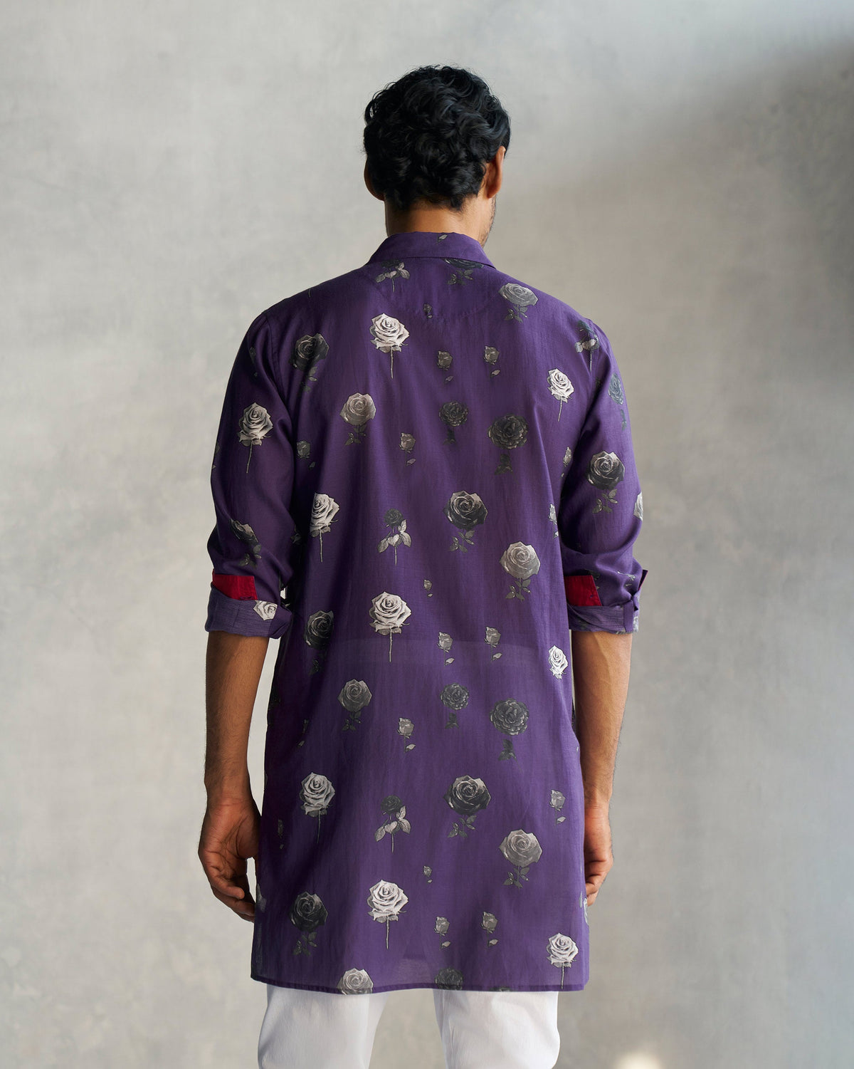 Back of a purple Bouquet Kurta with a rose print, worn by a person.