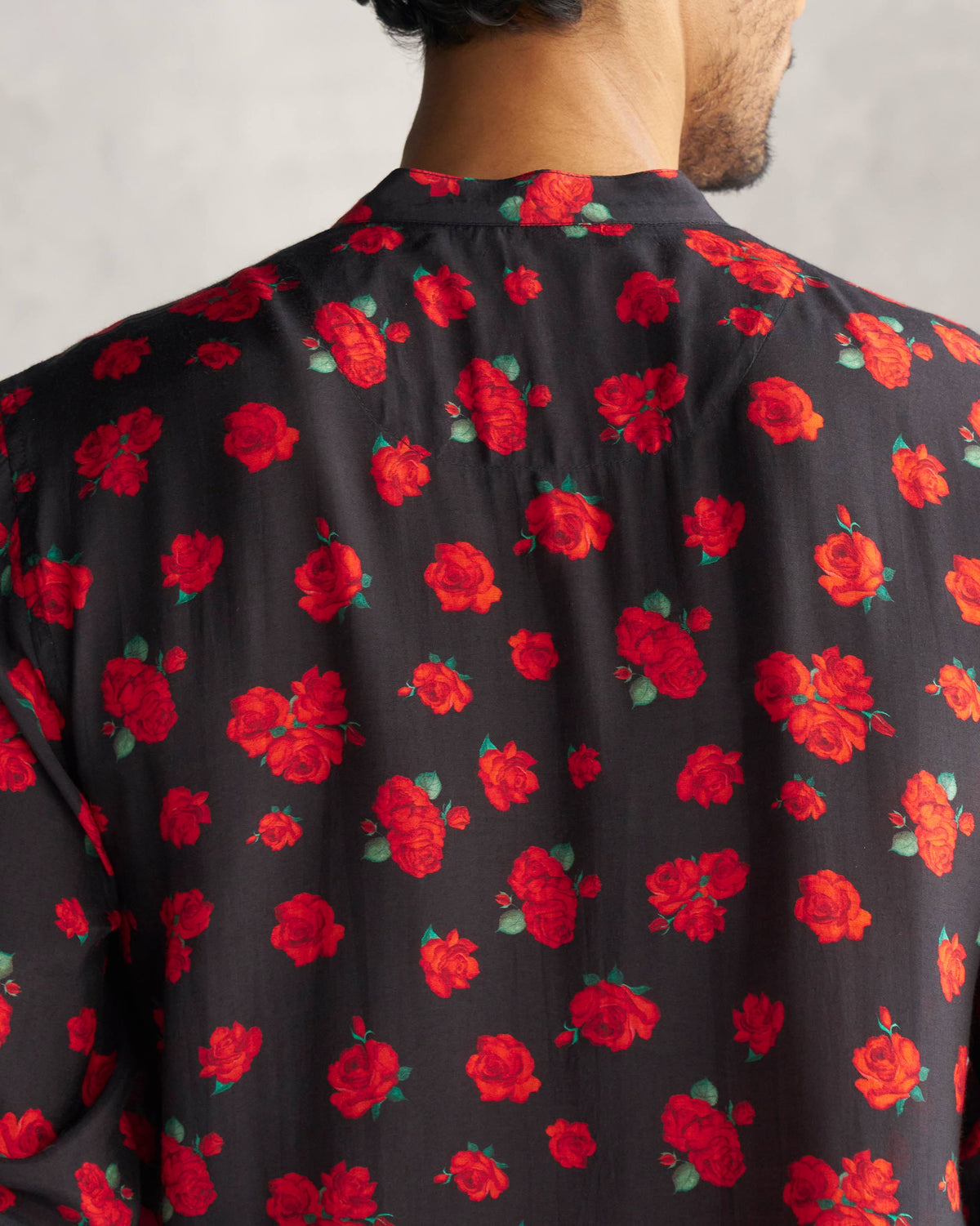Close-up of a black Bageecha Kurta showing red roses across the back yoke.