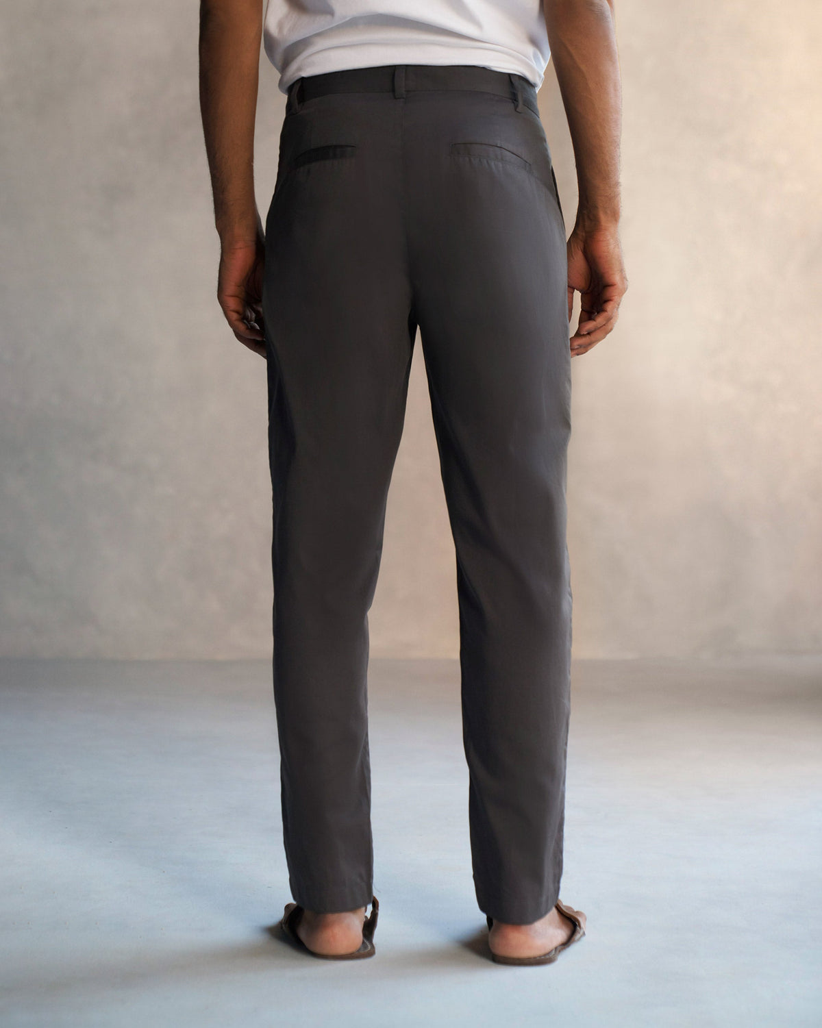 Back of dark grey Coast Pants worn by a person.