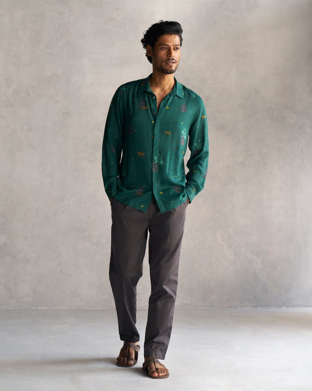 Full-length view of dark grey Coast Pants worn by a person.
