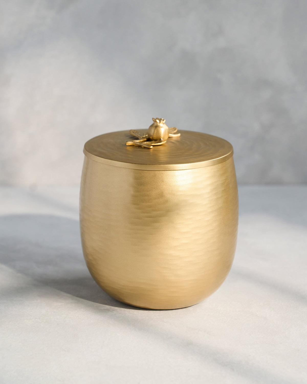 Side view of the Anar ice bucket with a pomegranate on its lid.