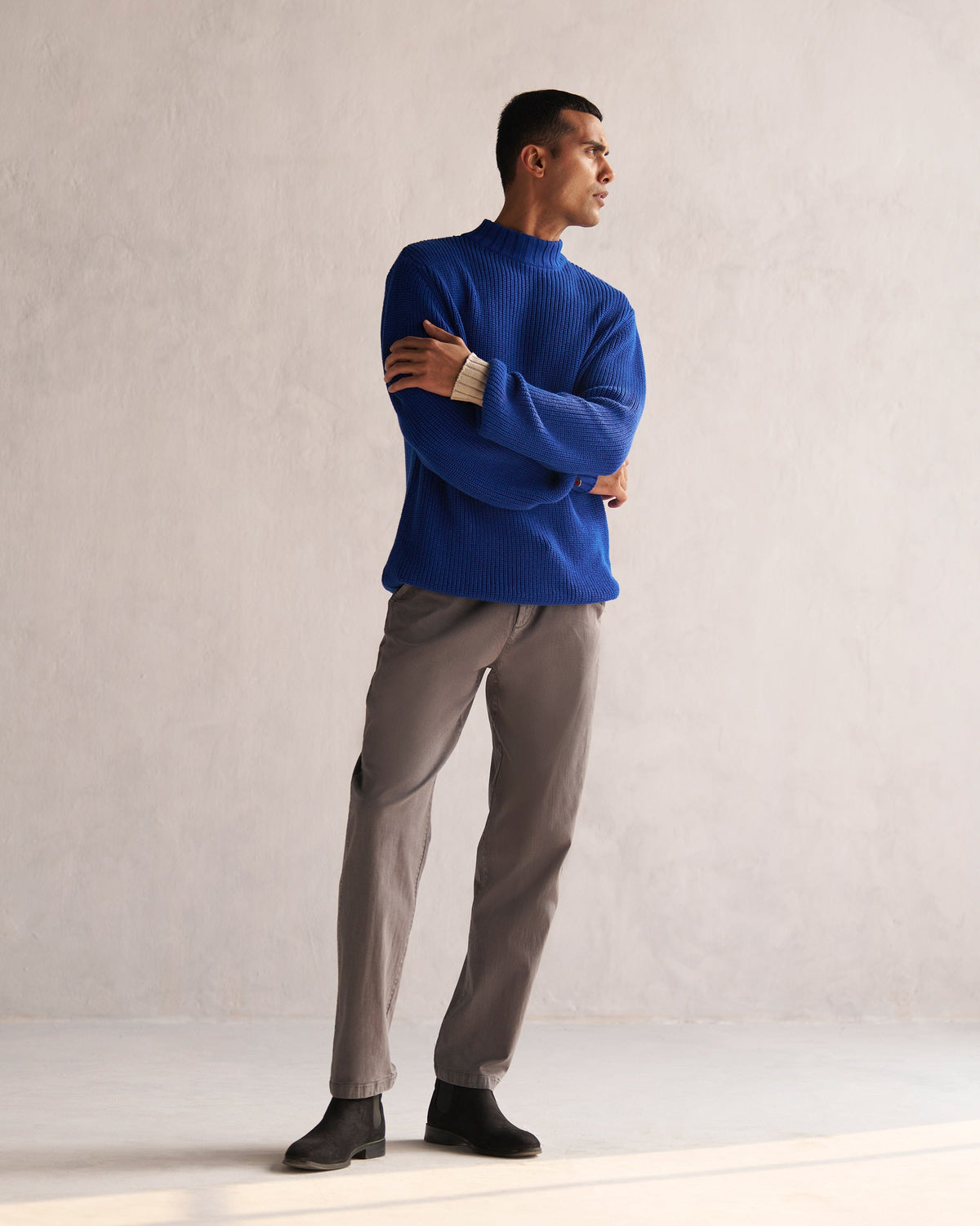Full-length view of a blue Coast sweater worn by a person.