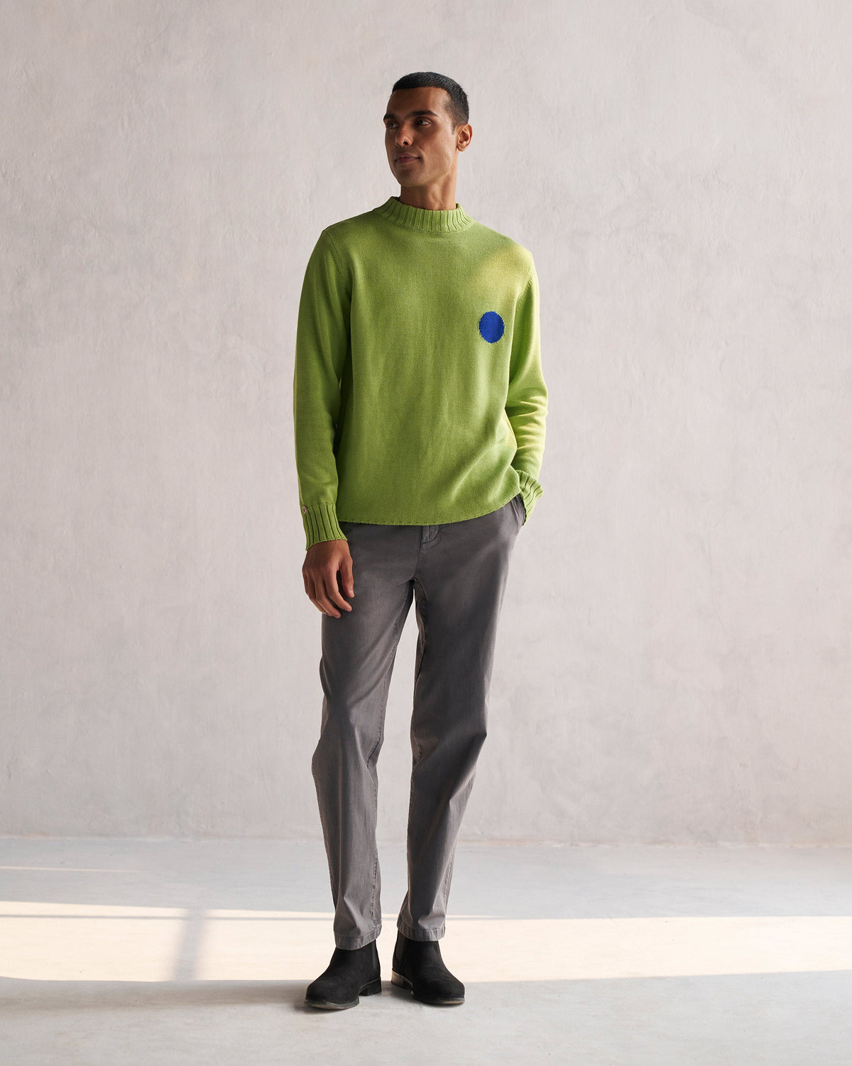 Full-length view of green Coast Crew-Neck Sweater worn by a person.