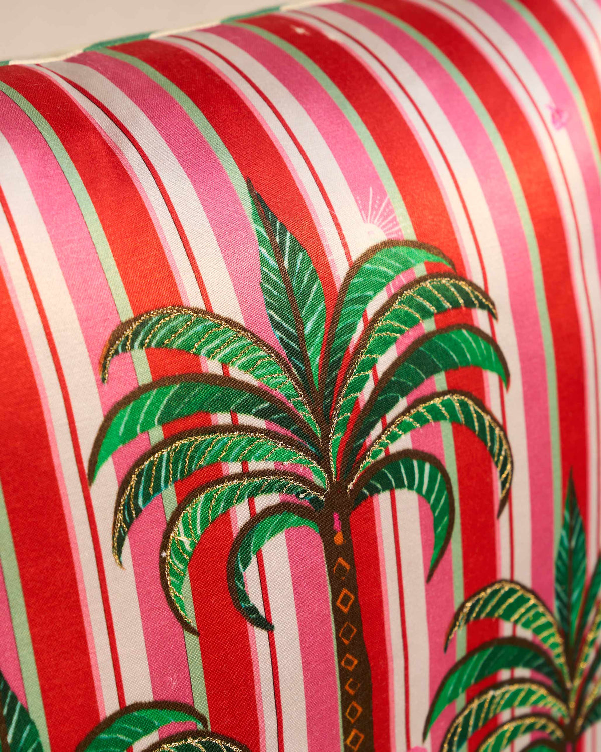 Close-up of the Candy Cushion Cover showing a green palm tree on pink and red stripes.