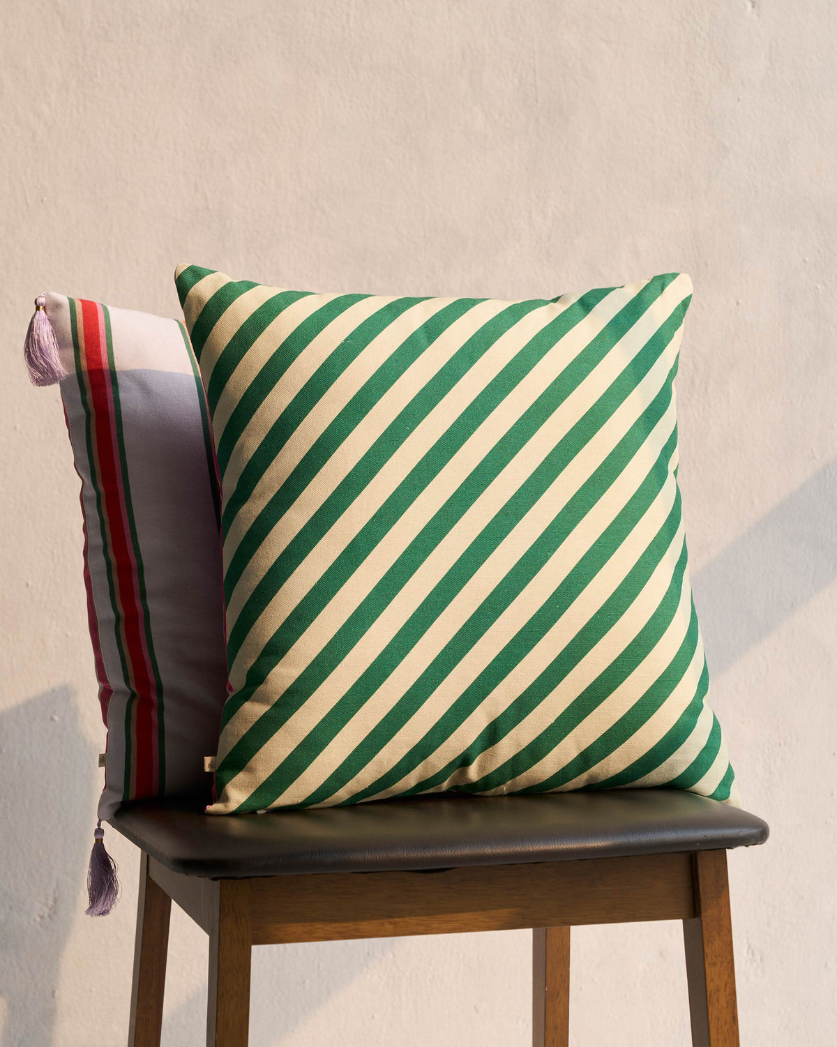 Candy Cushion Cover with diagonal green and cream stripes.