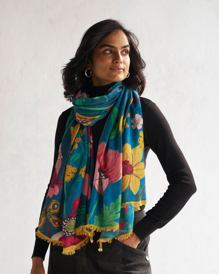 Person wearing a Garden Shawl in teal with pink and yellow flowers.
