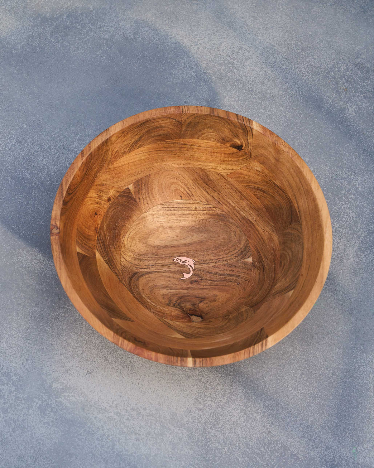 Garden Salad Bowl from above, with a copper-toned fish motif inside.