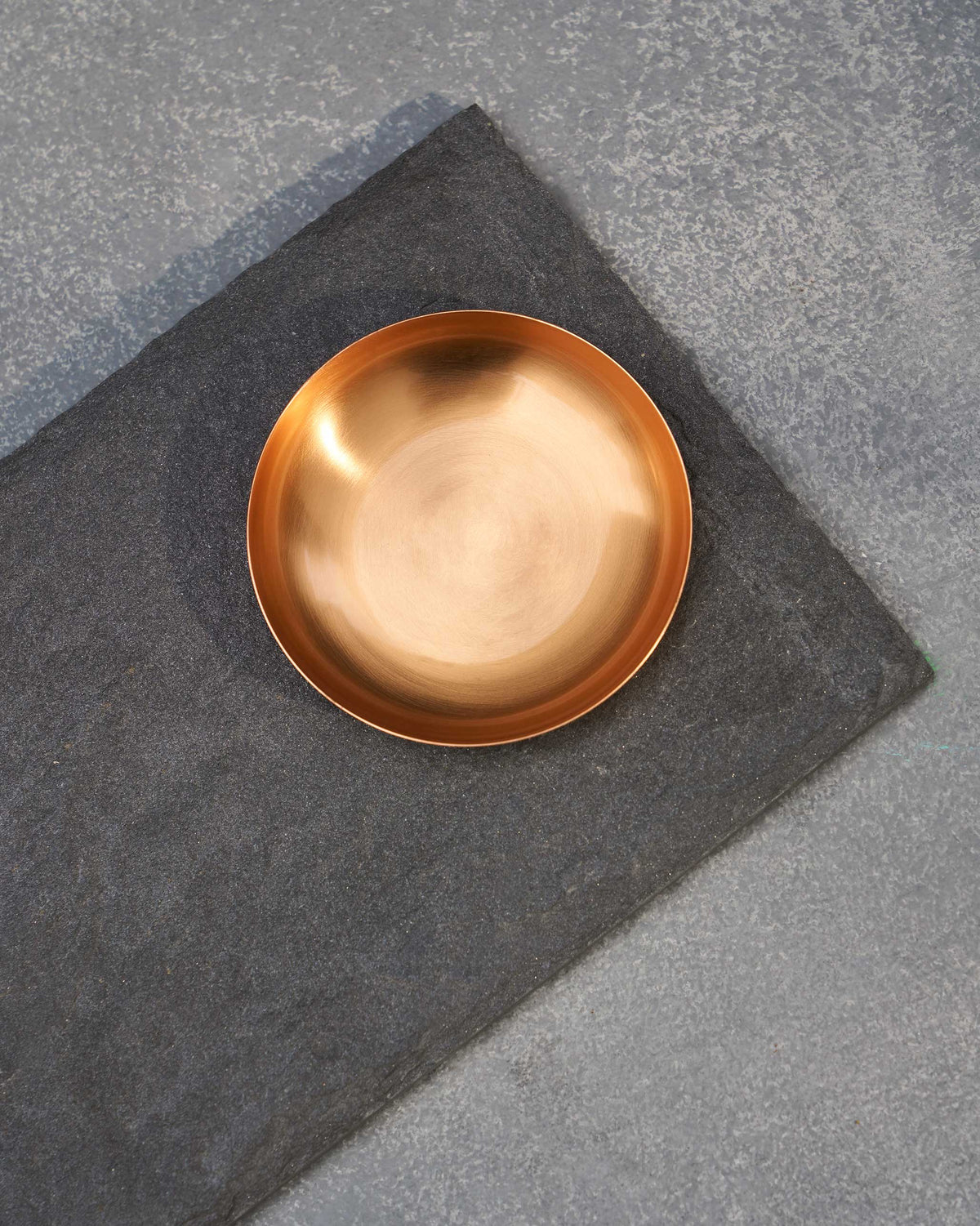 Close-up of Luna Chip & Dip Platter's round gold-toned bowl on a dark grey platter.