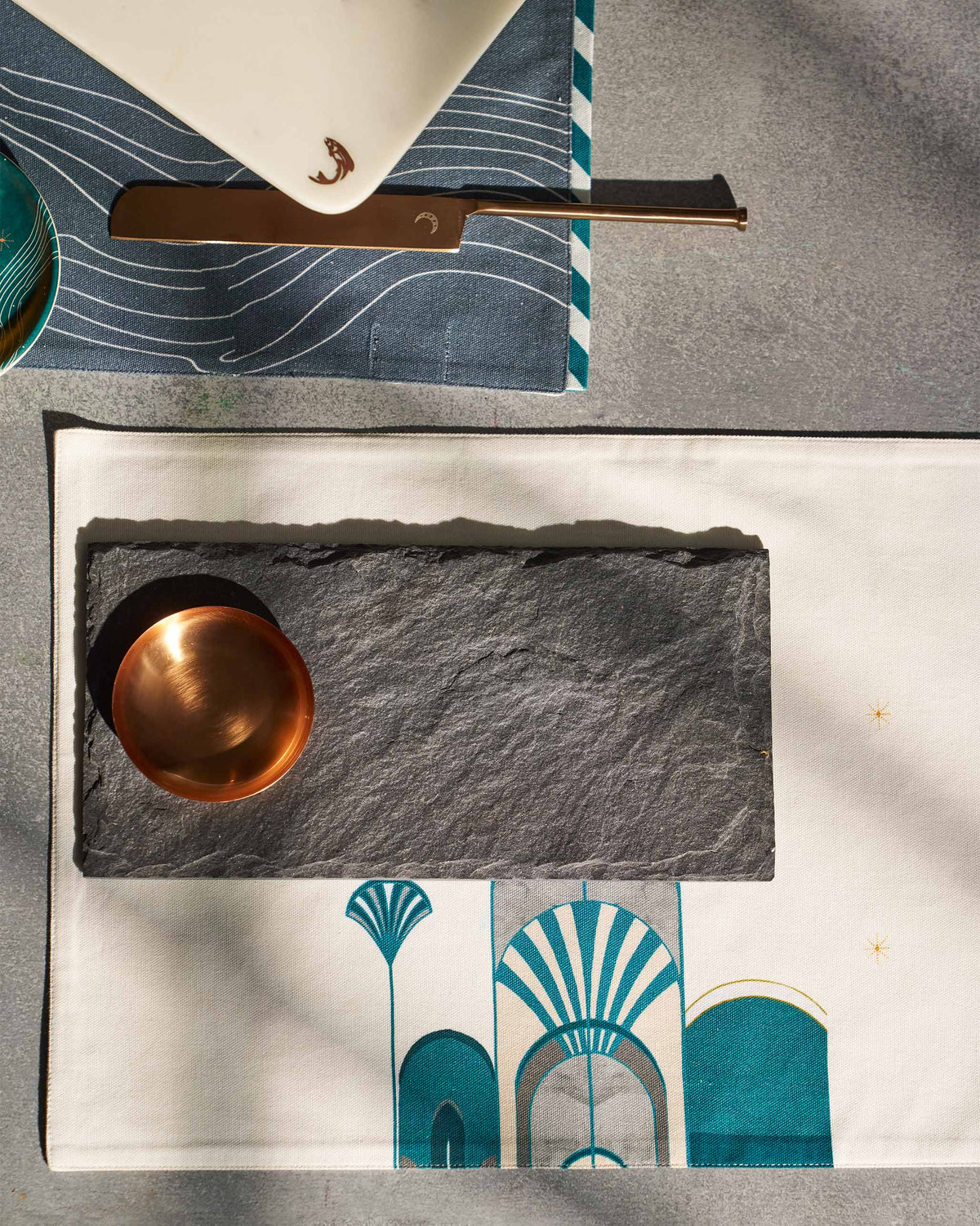 Overhead view of Luna Chip & Dip Platter with a gold-toned bowl on a printed cloth.