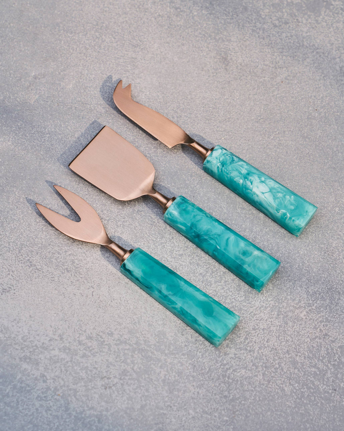 Teal Knife (Set of 3) with copper-toned blades and teal marbled handles laid flat.