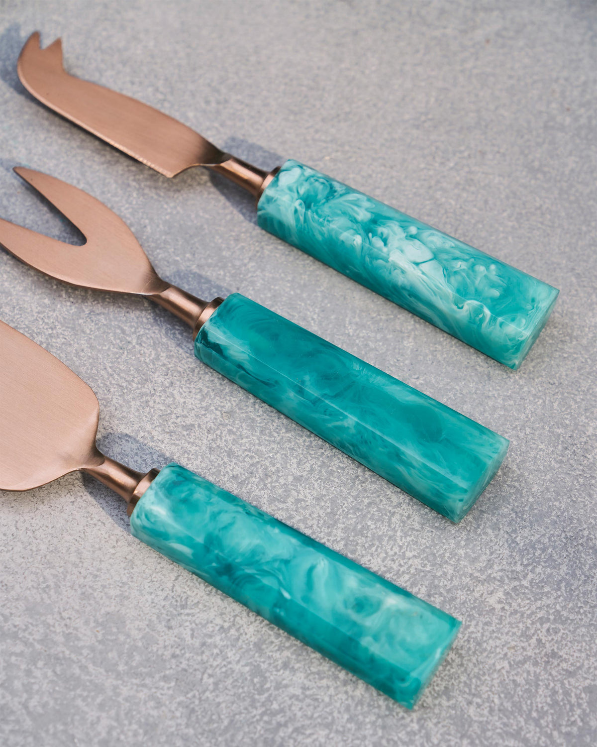 Teal Knife (Set of 3) fanned out to show the marbled teal handles.