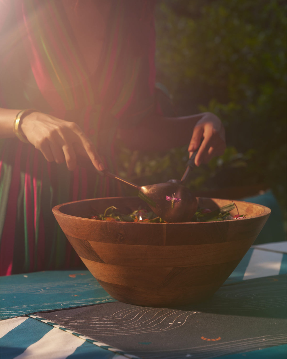 Person serving salad from a wooden bowl with the Garden Salad Server.