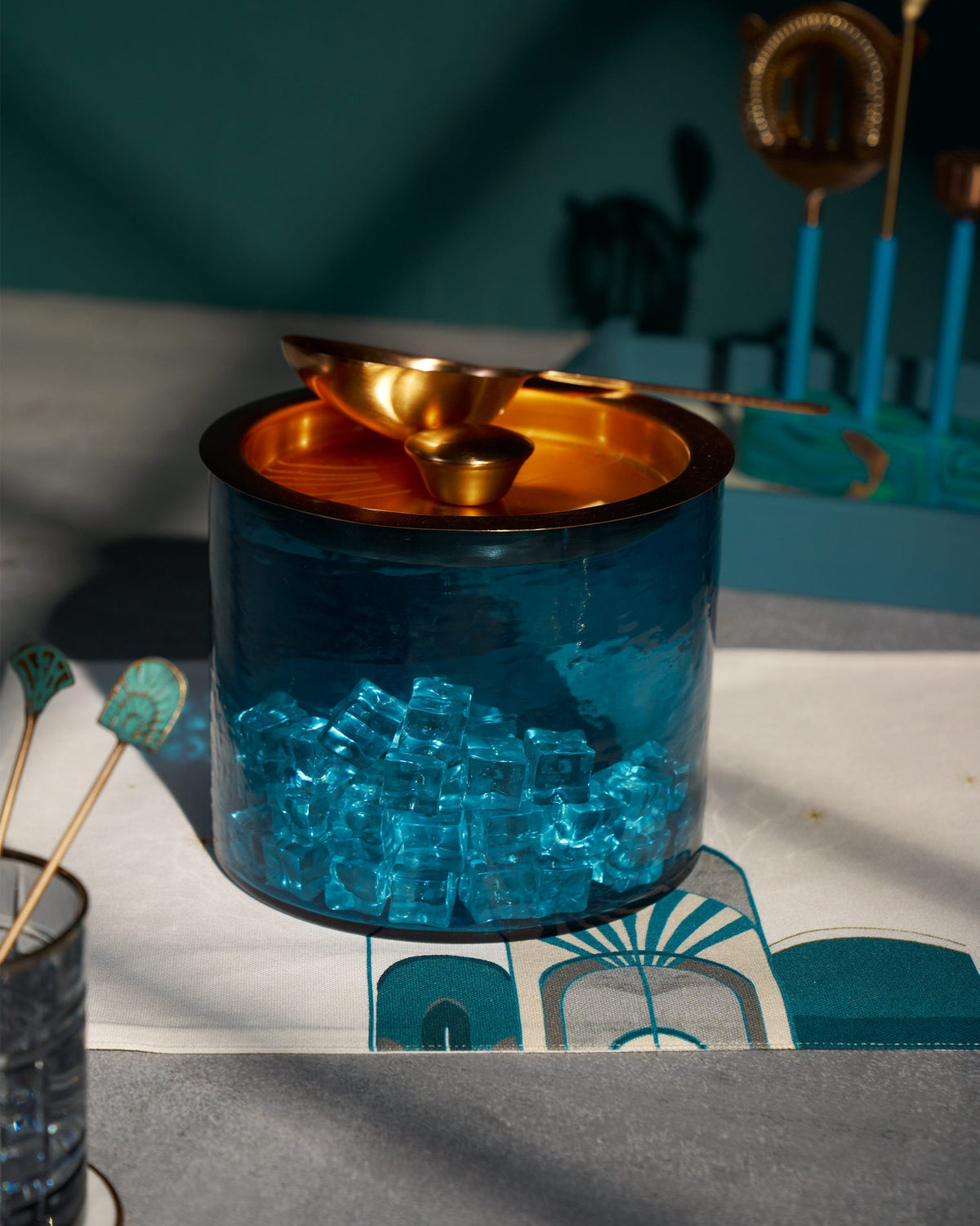 Azure Ice Bucket filled with ice cubes, with a scoop resting on its lid.