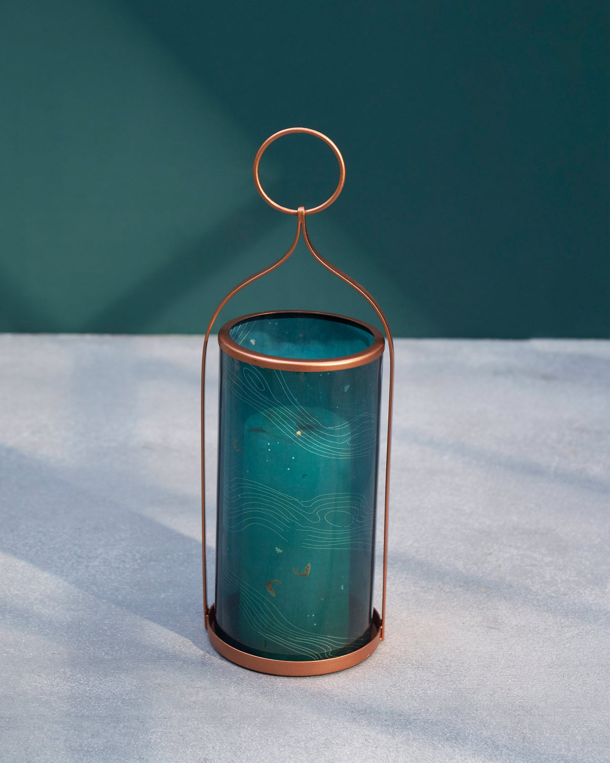 Front view of the Pacific Lantern with teal glass and a copper frame.