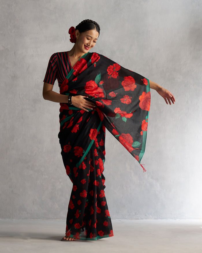Person wearing black Bentota Bloom Sari with a red rose print.