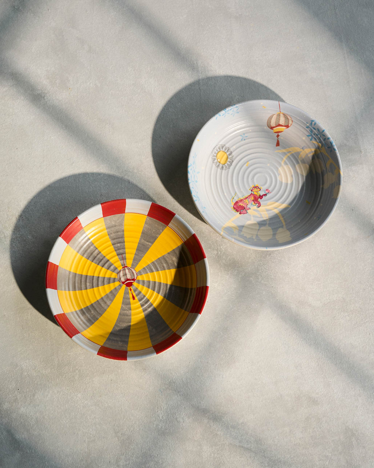 Pair of Chakra Shallow Bowls from above, the striped one in front.