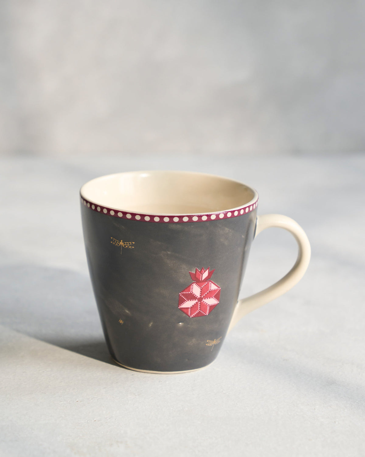 Anar Conical Mug from the side, with its cream handle.