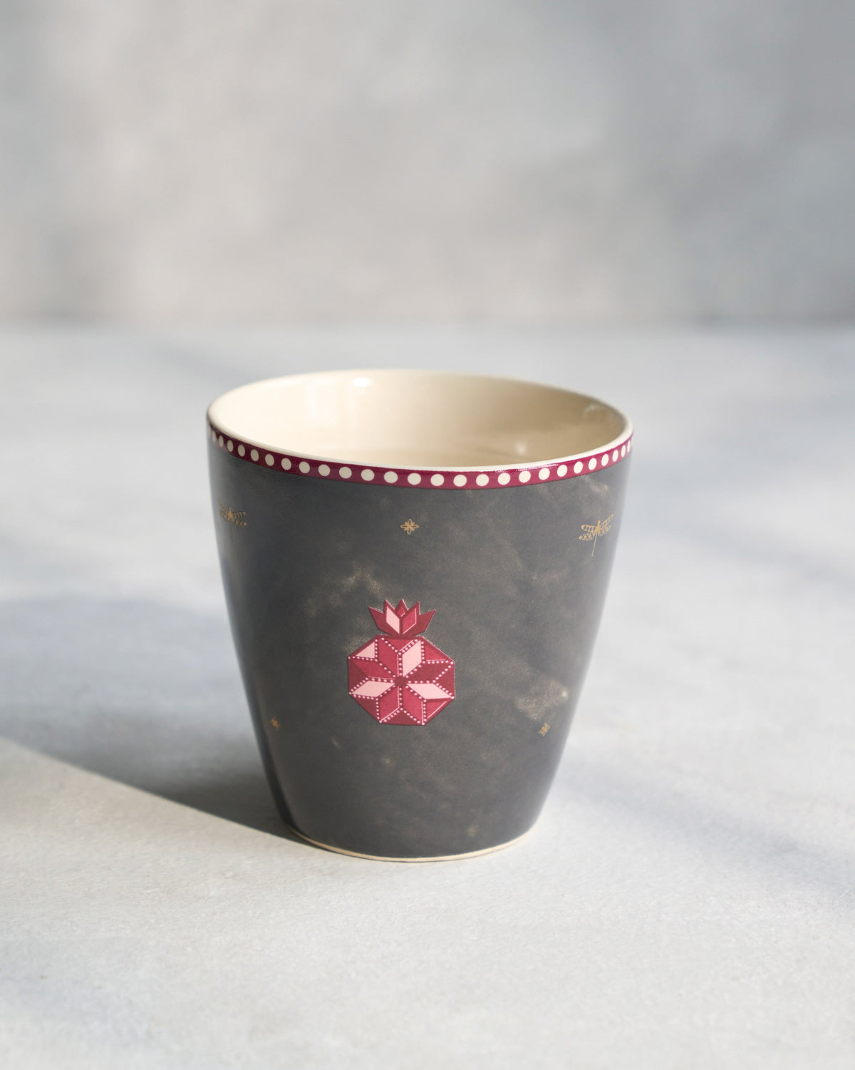 Anar Conical Mug without a handle, showing its pink pomegranate motif.
