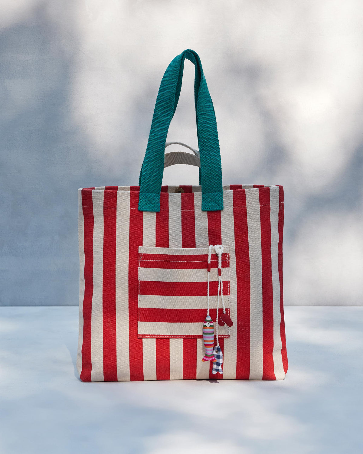 Straight-on view of the Bagan Stripe Tote with teal handles.