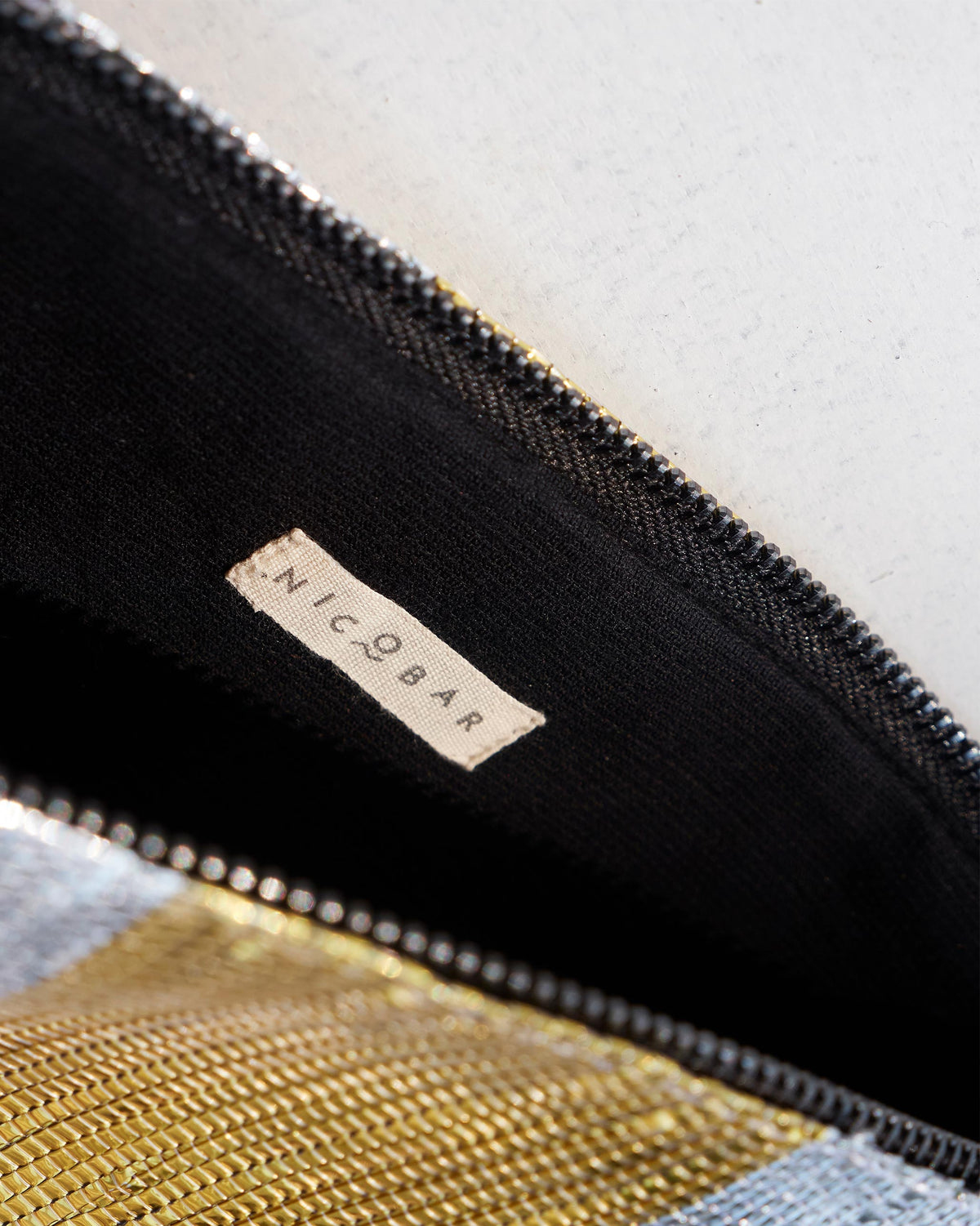 Interior of the Seher Clutch with its black lining and zip.