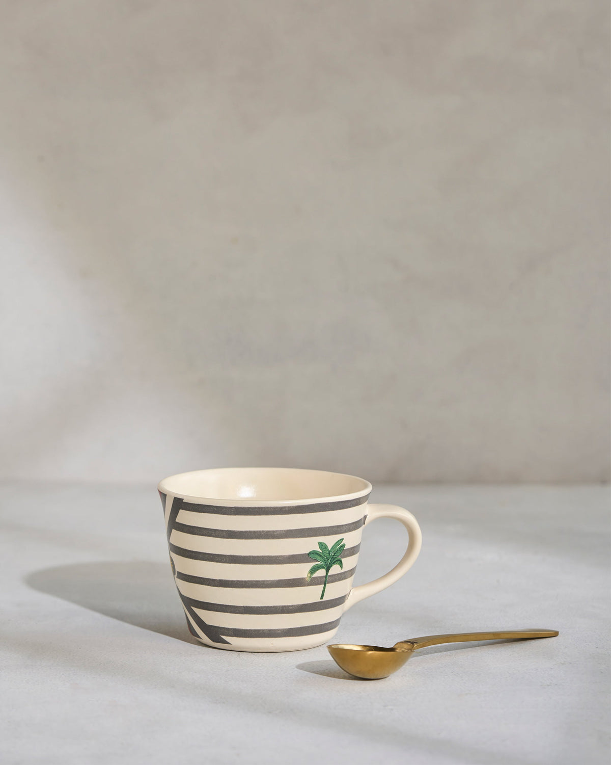 Side view of the Leafty Affair Soup Mug with a green palm motif.