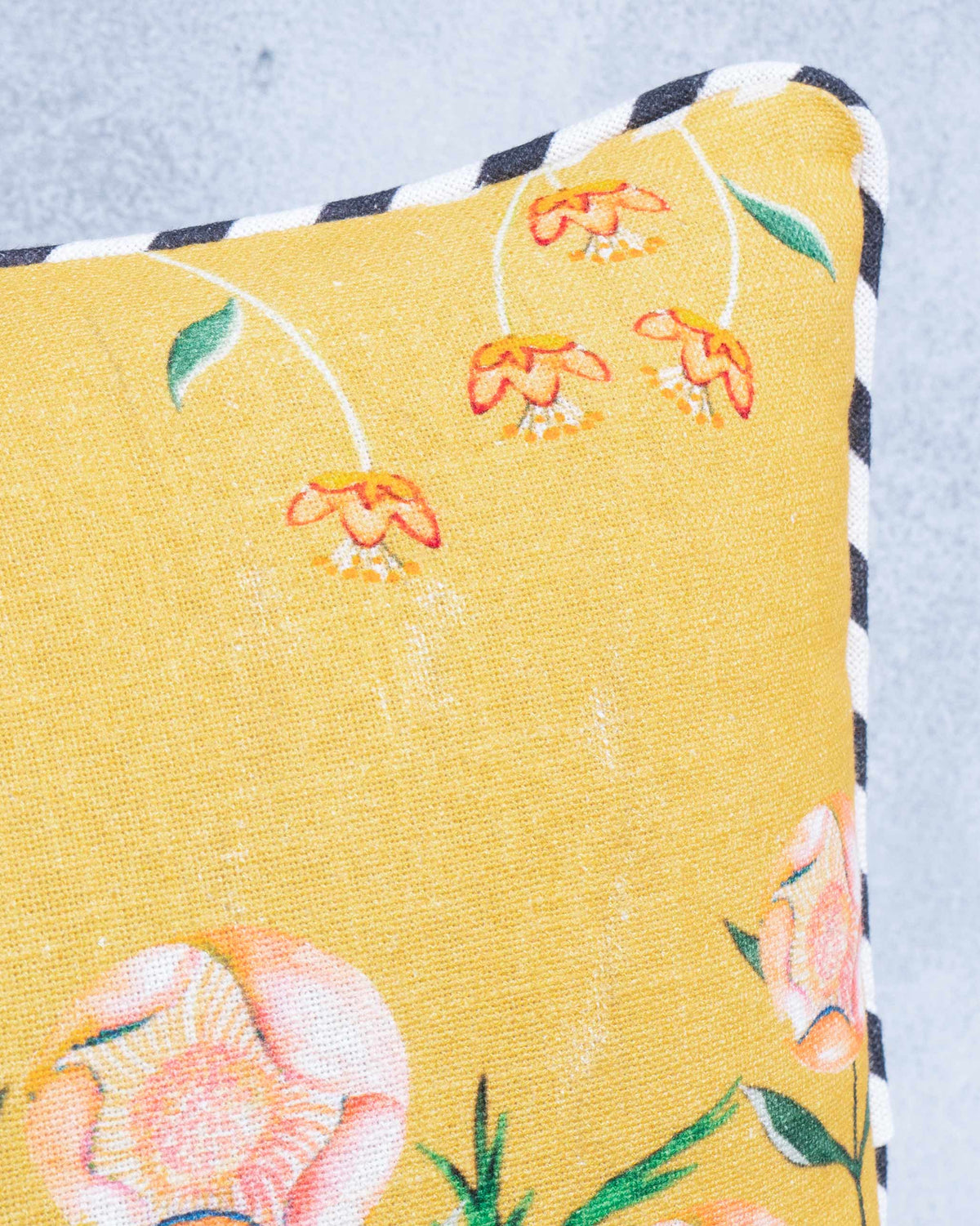 Close-up of the Flamingo Cushion Cover showing its floral print and striped edging.