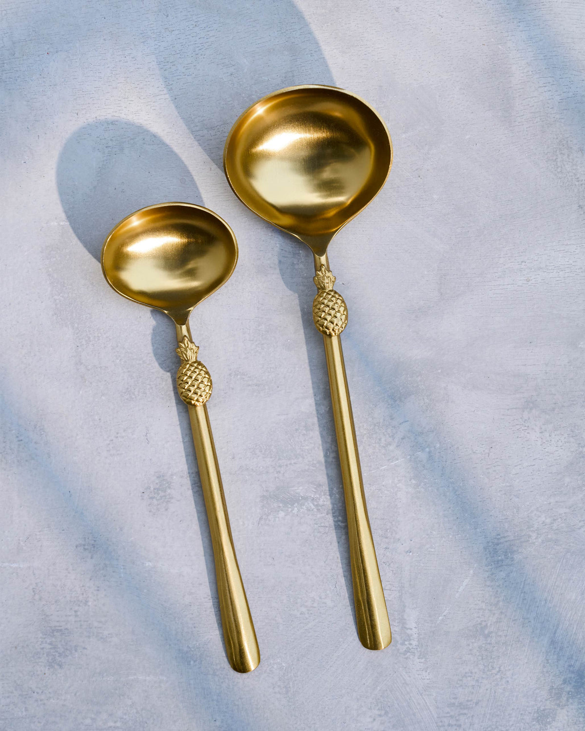 Pair of gold Pineapple Serving Spoons with pineapple-shaped handle details.