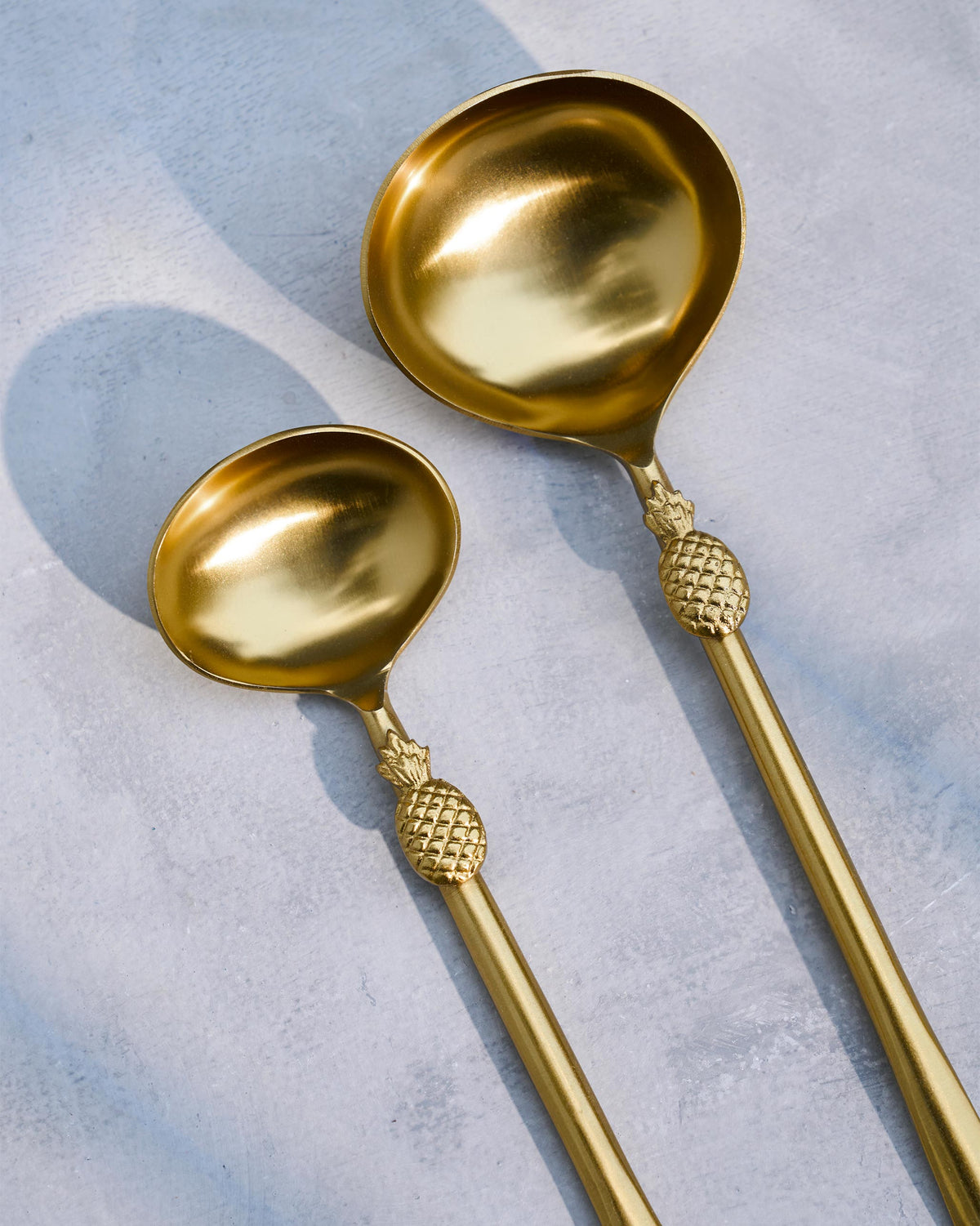 Close-up of the Pineapple Serving Spoon showing its pineapple-shaped handle knob.