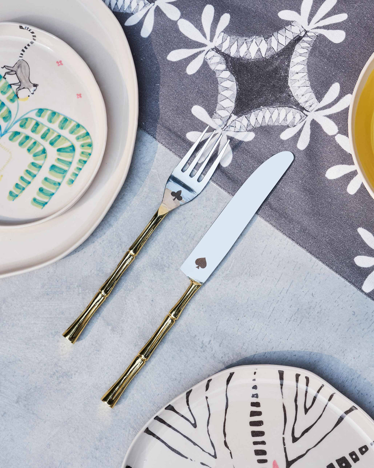 Spade & Club fork and knife resting on a table, with a spade cut-out on the knife blade.