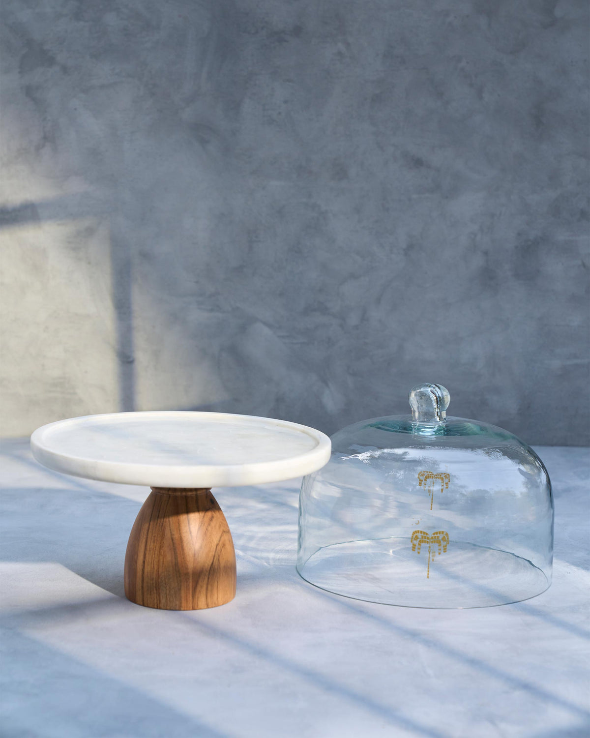 Safari Cloche stand and glass dome set side by side.