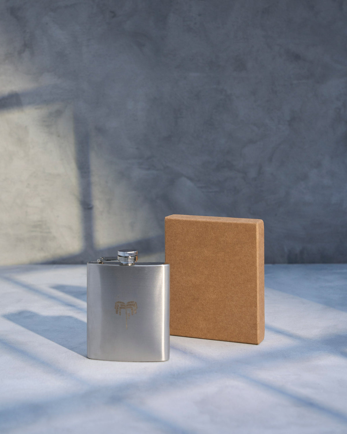 Safari Flask beside its brown gift box.
