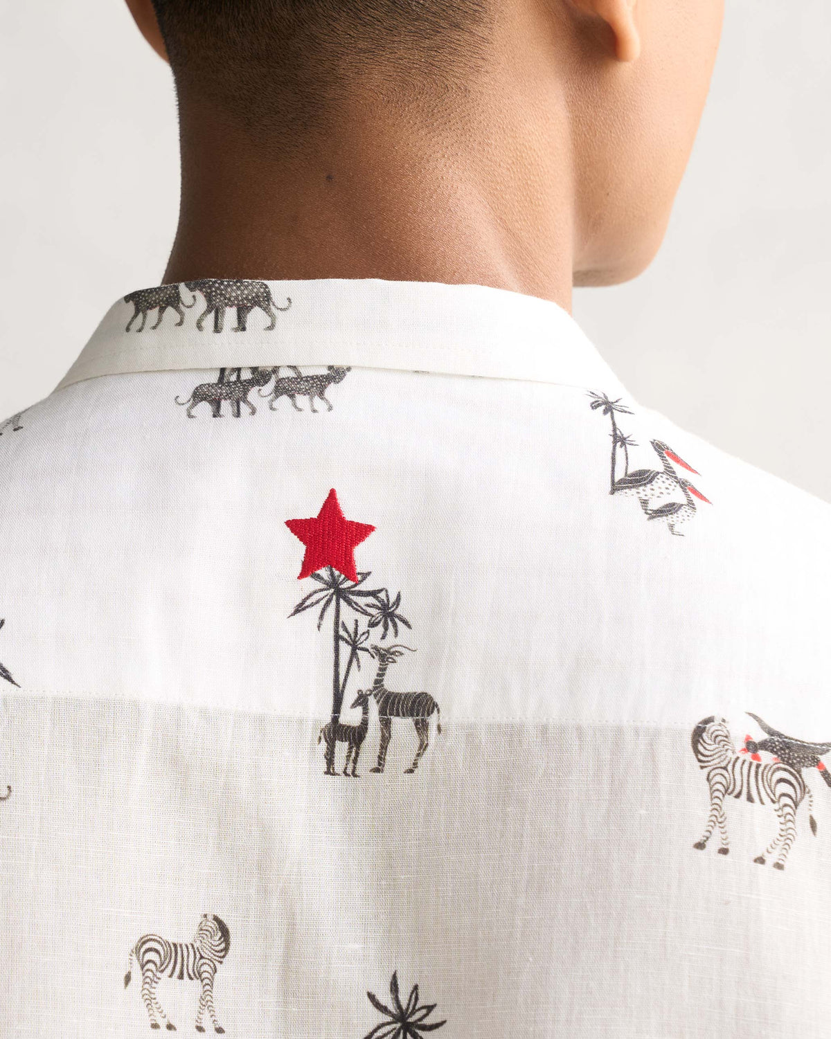 Close-up of the Riverline Shirt back collar showing a red embroidered star motif.