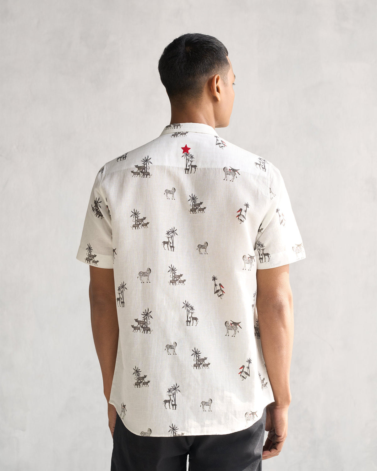 Back of a Riverline Shirt in ivory with a small red embroidered star at the yoke.