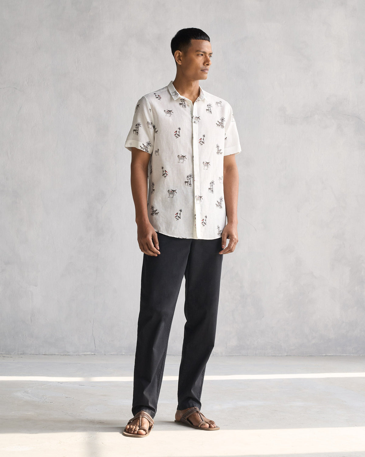 Full-length view of a Riverline Shirt in ivory worn by a person.