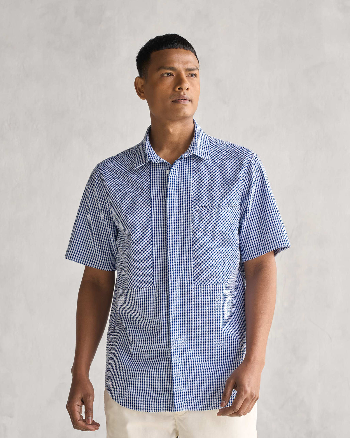 Person wearing the Holiday Shirt in blue and white gingham check.