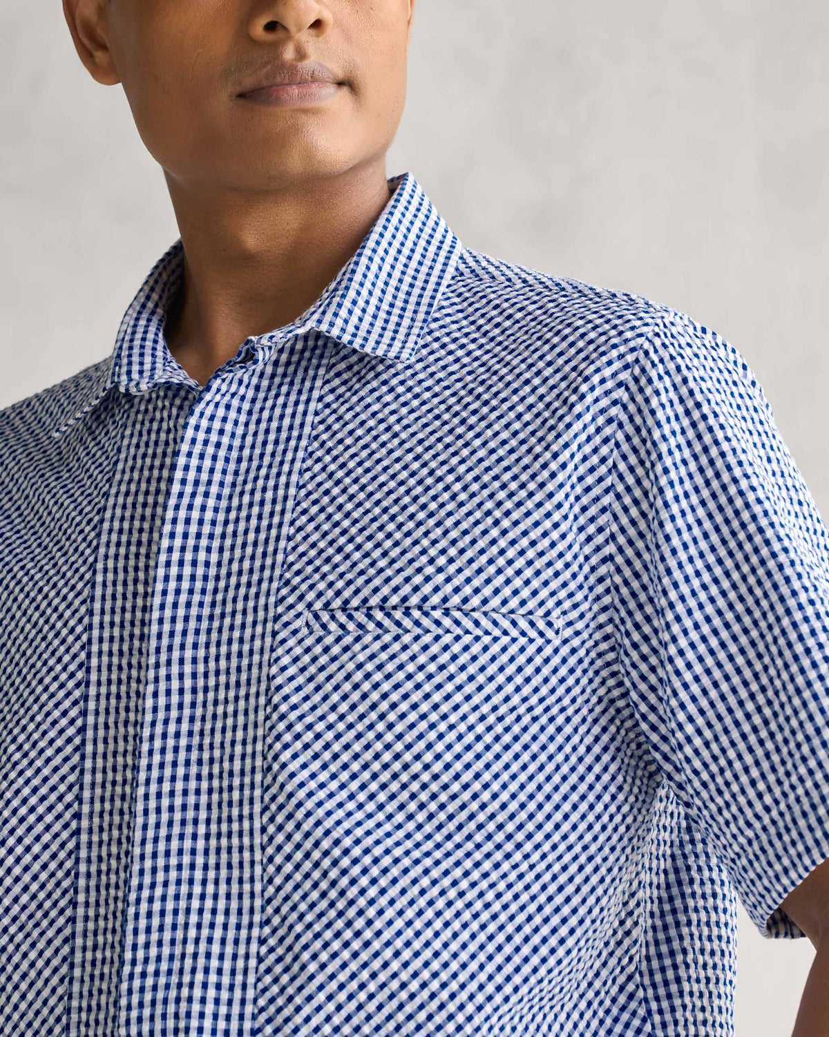 Close-up of the Holiday Shirt's chest pocket and collar in blue and white gingham check.