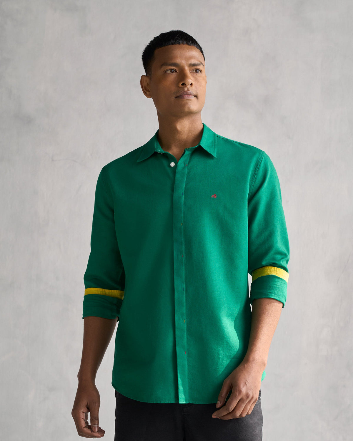 Person wearing the Captain shirt in green with yellow-trimmed cuffs.