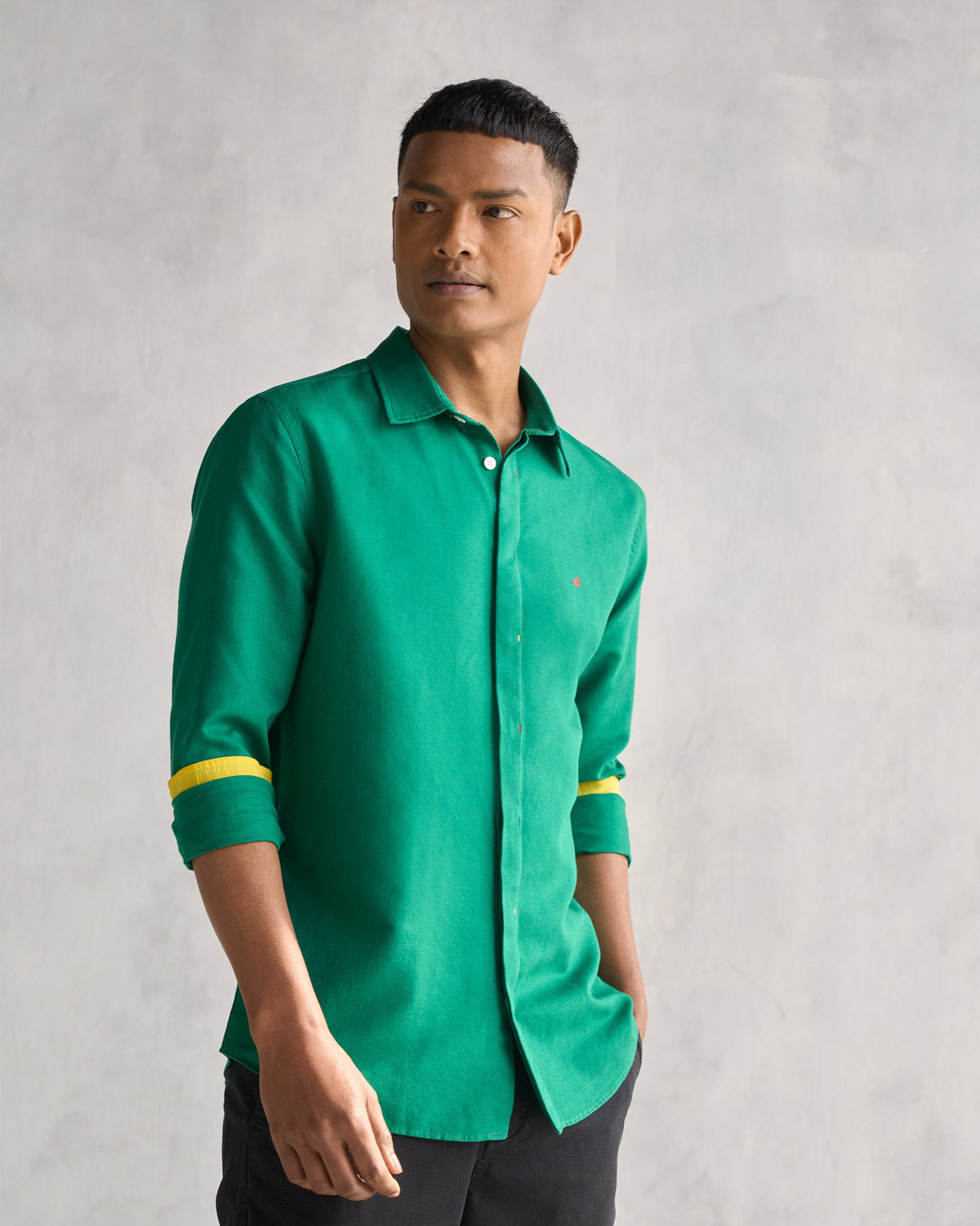 Person wearing the Captain shirt in green with a small embroidered mark on the chest.