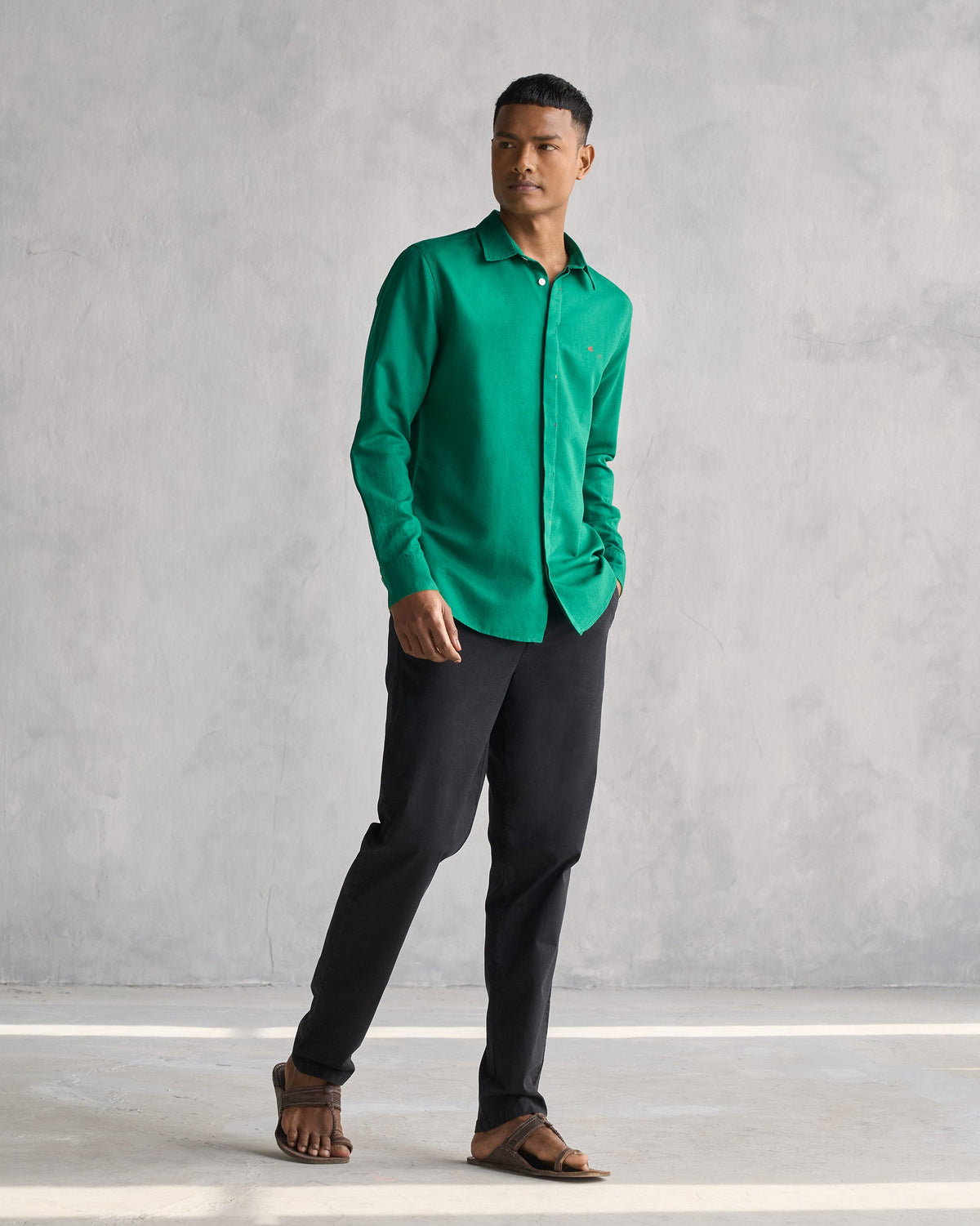 Person wearing the Captain shirt in green, shown full length.