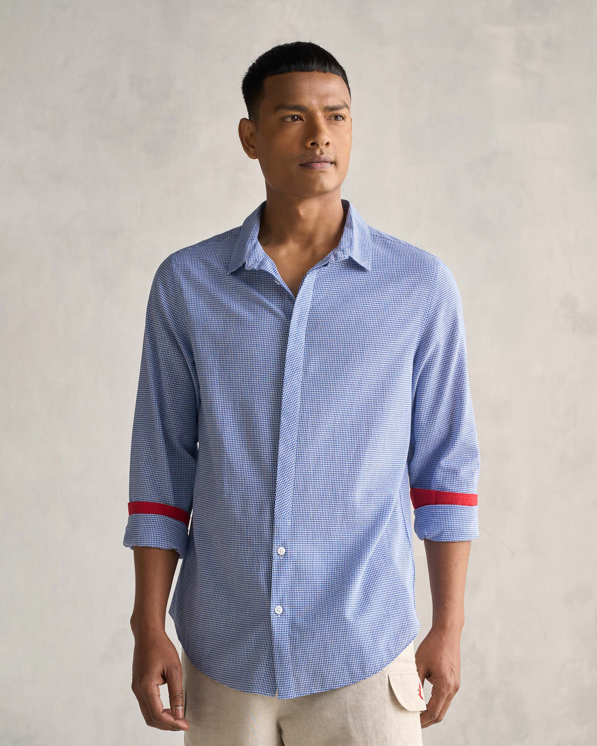 Person wearing the Bias Placket Shirt in blue checks with red cuff bands.