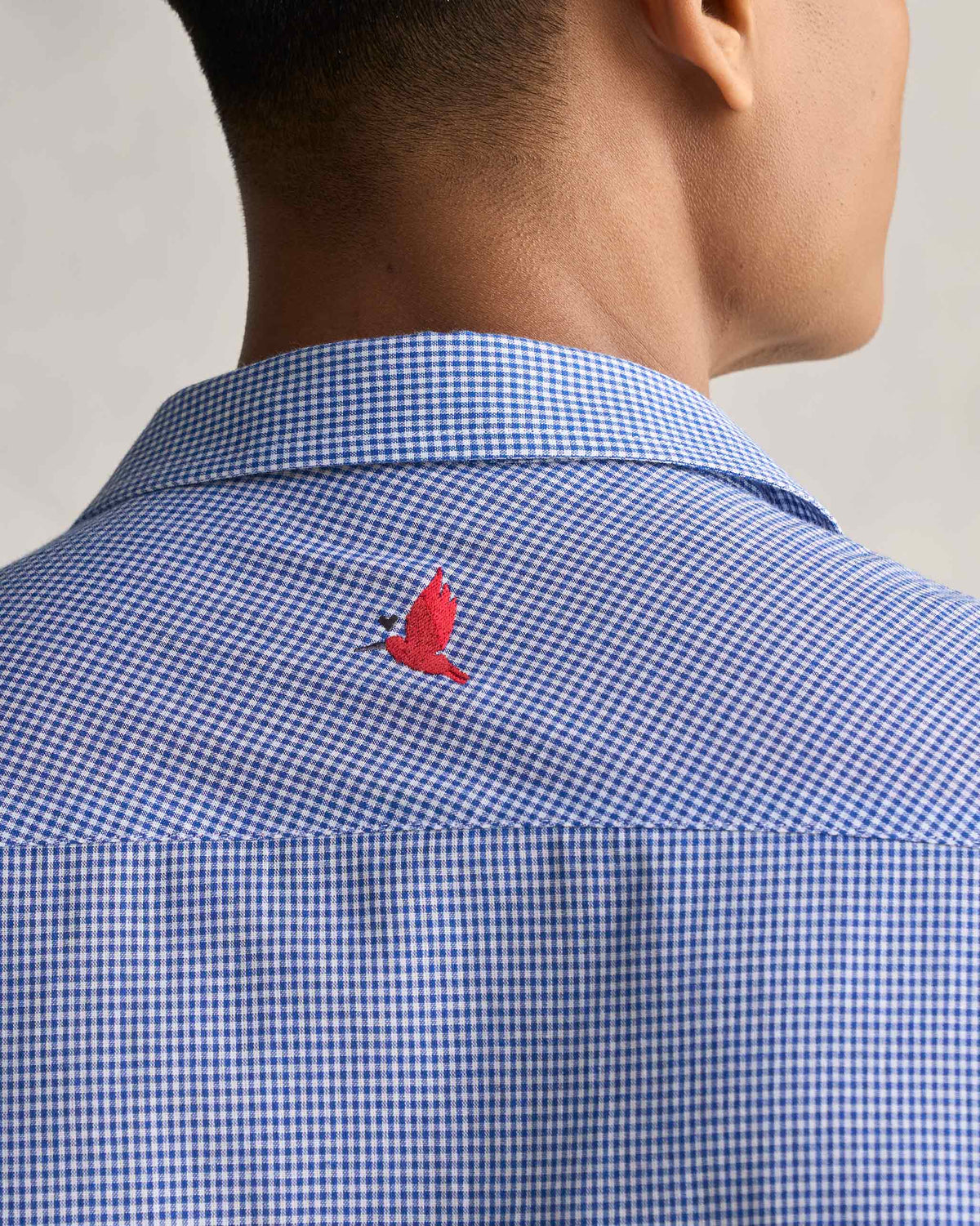Close-up of the Bias Placket Shirt back yoke showing a small red bird embroidery.